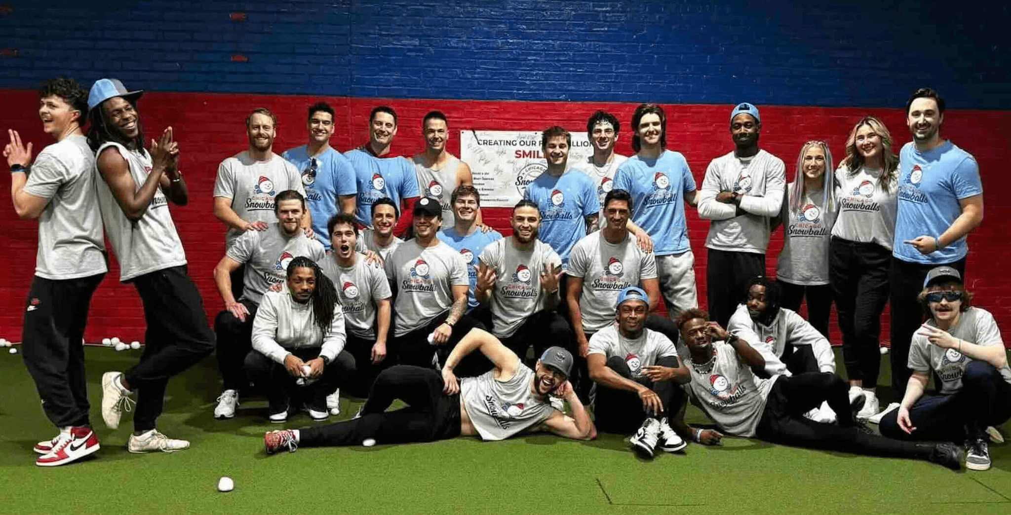 The full Chicago Snowballs squad packed together for a group photo on the turf, some kneeling and lying across the front row